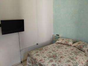 a bedroom with a bed and a flat screen tv at Cantinho da Paz in Socorro +26 photos