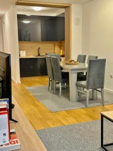a kitchen and dining room with a table and chairs at Snow Base Jahorina in Jahorina