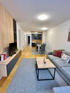 a living room with a couch and a table at Snow Base Jahorina in Jahorina