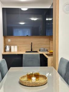 a kitchen with a table with two glasses on it at Snow Base Jahorina in Jahorina +21 photos
