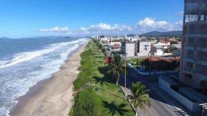 an aerial view of a beach with palm trees and buildings at Apartamento Barra Velha Praia do Tabuleiro in Barra Velha
