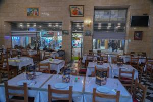 a dining room with white tables and chairs at Appart-Hôtel BEL ANFA in Casablanca