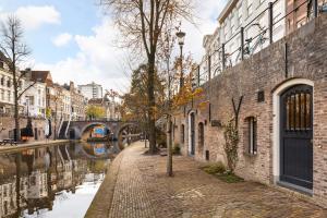 a street in a city with a canal and buildings at Luxurious canal apartment in Utrecht A Location in Utrecht