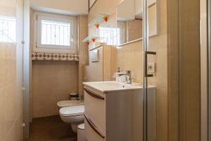 a small bathroom with a sink and a toilet at Youhosty - Paul Valery Bis in Milan +17 photos