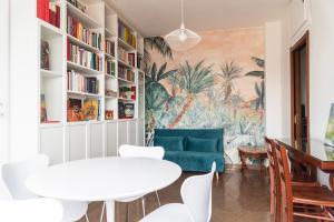 a living room with a couch and a table and chairs at Youhosty - Paul Valery Bis in Milan