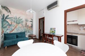 a living room with a blue couch and a table at Youhosty - Paul Valery Bis in Milan