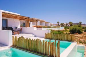 a house with a swimming pool and a fence at Aegean Hospitality in Mýkonos City