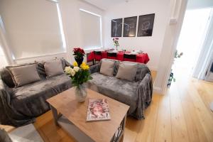 a living room with a couch and a table at Harrods Flats in London