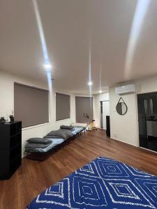 a room with two beds and a blue rug at Convenience & Luxury Apartment in Melbourne