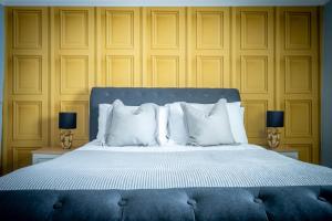 a bedroom with a large bed with white pillows at Walmgate Cottage in York +7 photos