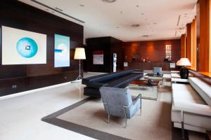 a living room with a couch and a table at AC Hotel Guadalajara by Marriott, Spain in Guadalajara +40 photos