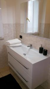 a bathroom with a white sink and a mirror at Guest House Brezza Marina in Fiumicino