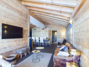 a living room with a couch and a tv on a wall at Luxueux Appartement 4* Alpin, 5 Pièces, 4 Ch, Proche Pistes, Parking, WiFi - FR-1-398-549 in La Rosière