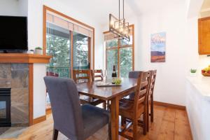 eine Küche und ein Esszimmer mit einem Holztisch und Stühlen in der Unterkunft Northstar Whistler Village Resort in Whistler