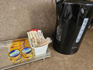 ein Tablett mit Essen neben einer Kaffeekanne in der Unterkunft Two bedroom holidays apartment, walking distance to the beach and Harbour in Paphos