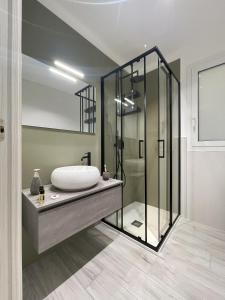 a bathroom with a sink and a glass shower at Dione Casa Vacanze Donnalucata - Verde in Donnalucata