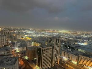 an aerial view of a city at night at Spacious 3BR PLUS MAID ROOM in Sharjah