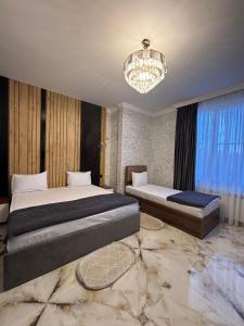 Postel nebo postele na pokoji v ubytování Mirvarim Hotel