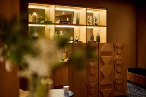 a cabinet filled with lots of vases on display at 6 VH Hotel in Paris