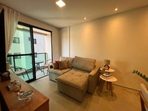 a living room with a couch and a table at Ap Liv Residence Ponta verde - Castelo B temporada in Maceió