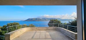 a view of the ocean from the balcony of a house at Marina-piscine privée-wifi-Accès Sporting Club Marina di Fiori in Porto-Vecchio