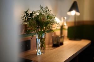 a vase of flowers sitting on a table at 6 VH Hotel in Paris