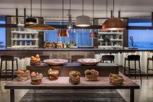 a bar with bowls of food on a table at AC Hotel Gran Canaria by Marriott in Las Palmas de Gran Canaria