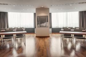 a conference room with tables and chairs and a podium at AC Hotel Gran Canaria by Marriott in Las Palmas de Gran Canaria +51 photos