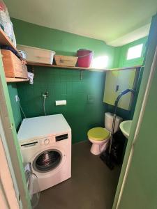 a washing machine in a bathroom with a toilet at Le Petit Duplex du Quartier-Haut in Sète +14 photos