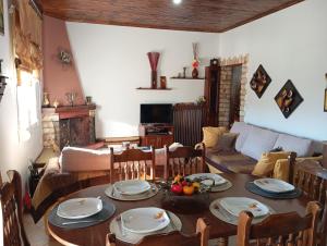 a living room with a table and a couch at The Stoners apartment in Kalabaka +7 photos