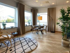 ein Esszimmer mit Tisch, Stühlen und Fenstern in der Unterkunft Rodergatan in Malmö