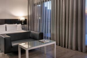 A bed or beds in a room at AC Hotel Atocha by Marriott