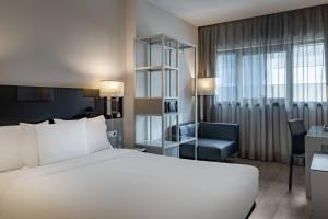 A bed or beds in a room at AC Hotel Atocha by Marriott