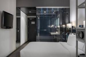 A bed or beds in a room at AC Hotel Atocha by Marriott