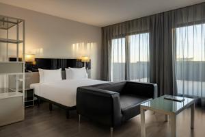 A bed or beds in a room at AC Hotel Atocha by Marriott