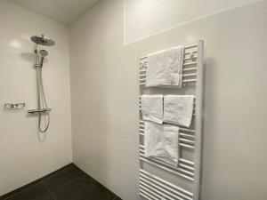 a bathroom with a towel rack with towels at Ferienwohnung EPIKUR in Payerbach