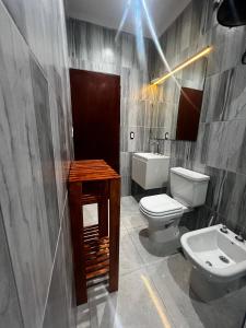 a bathroom with a white toilet and a sink at Aire y Sol in Concordia +14 photos