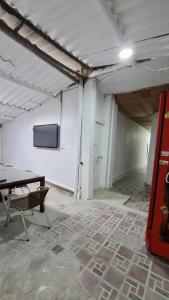 a room with a table and a tv in it at Casa Martín in Bogotá +12 photos