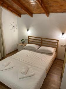 a bedroom with a bed with two towels on it at Elsa's Poem in Paralia Katerinis