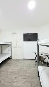 a white room with two bunk beds and a table at Casa Martín in Bogotá