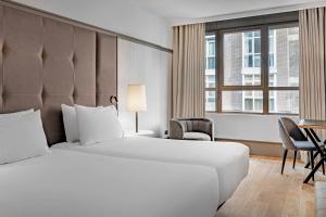 a hotel room with a bed and a desk at AC Hotel Avenida de América by Marriott in Madrid +38 photos
