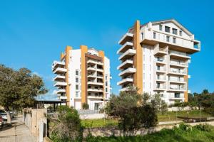 two tall apartment buildings next to each other at Alfiere Arc Loft by Klodge in Olbia