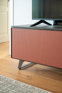 a flat screen tv sitting on top of a tv stand at Alfiere Arc Loft by Klodge in Olbia