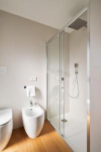 a bathroom with a sink and a glass shower at Alfiere Arc Loft by Klodge in Olbia +40 photos
