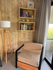 a room with a chair and a book shelf at Escapada romántica en El Leon in San Javier