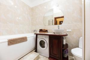 a bathroom with a washing machine and a sink at Kyiv Sheikh's Apartment in Kyiv +16 photos