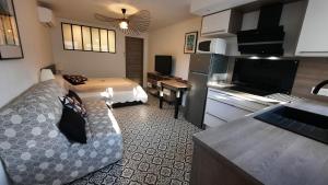 a small room with a kitchen and a living room at Studio climatisé Lantanas 4 personnes in Le Lavandou