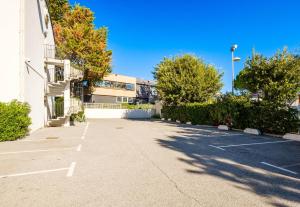 a parking lot in front of a building at B&B HOTEL Villeneuve Loubet Plage in Villeneuve-Loubet