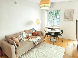 a living room with a couch and a table at Casa Moara - Downtown Duplex House in Porto