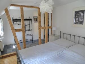 a bedroom with a bed and a wooden ladder at Stachelburg in Monschau